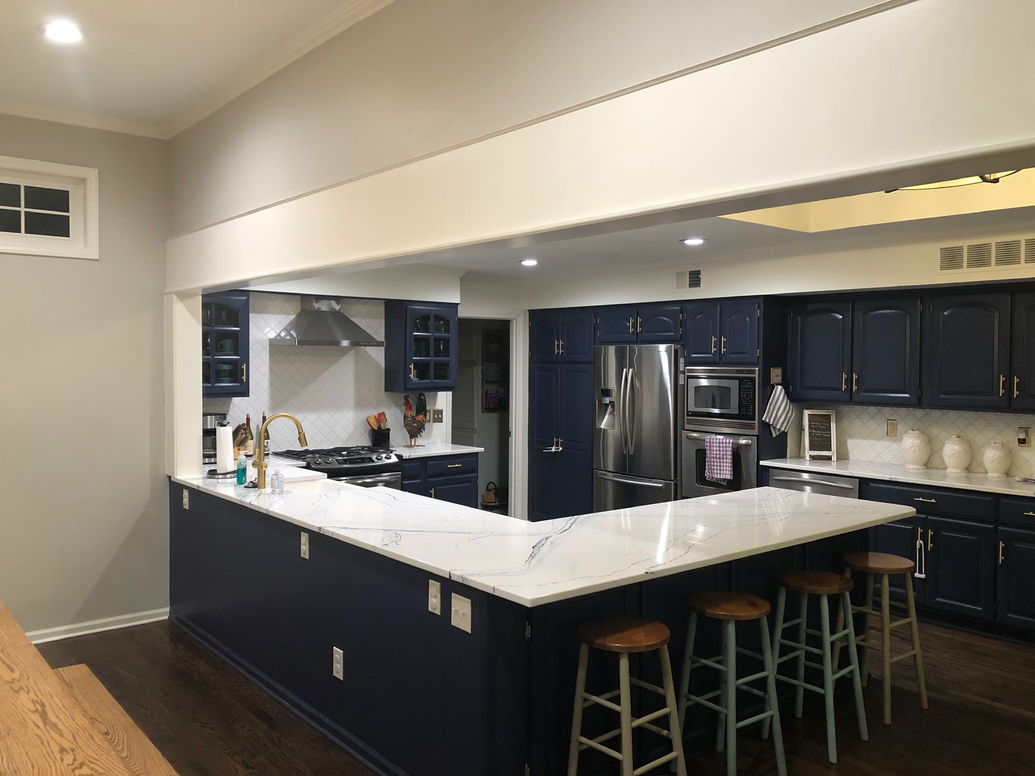Completed kitchen open to the surrounding living areas after two load-bearing walls were removed
