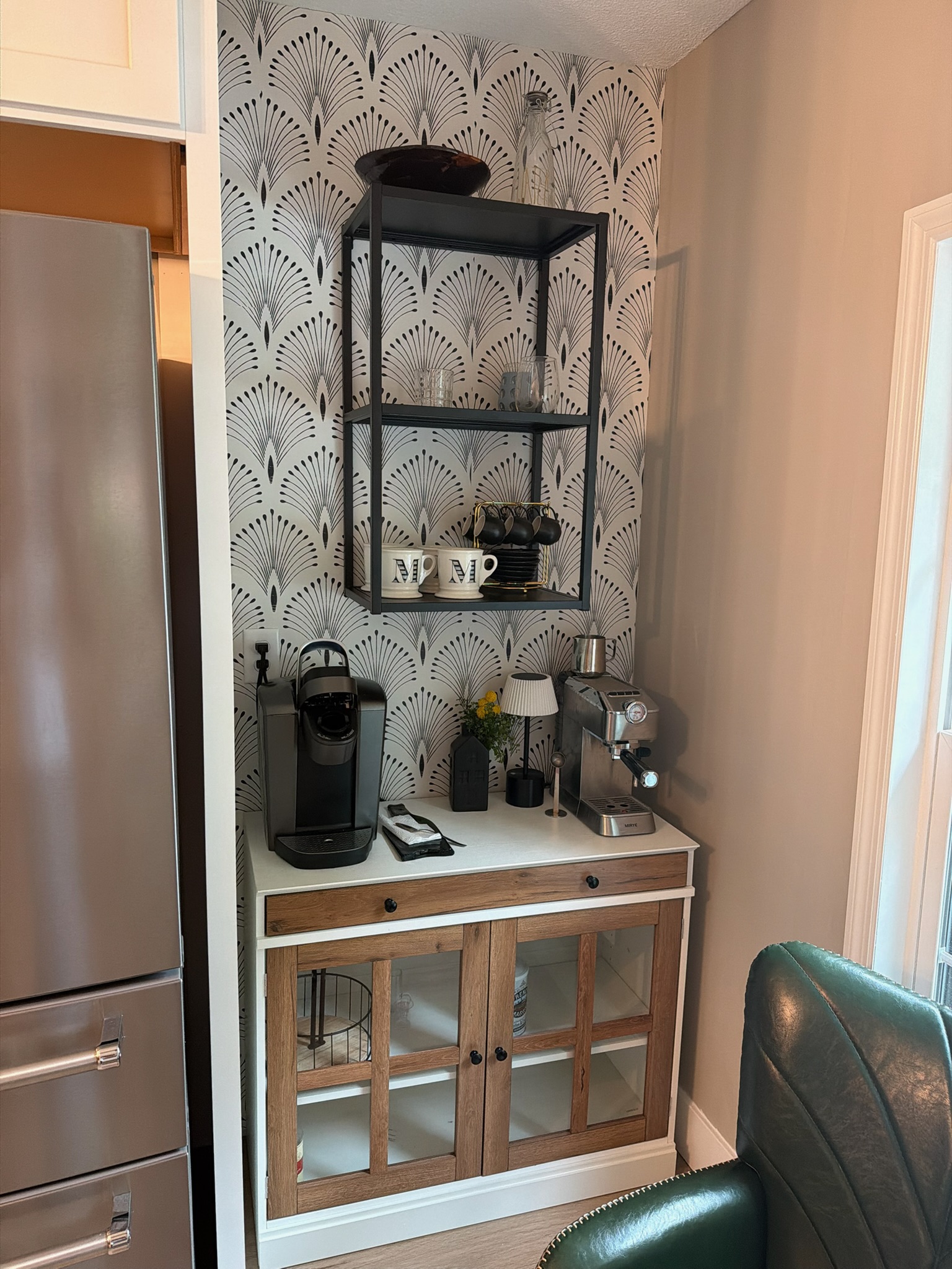 Custom built-in coffee area with patterned wall covering, shelving and cabinet storage in the former sliding-door opening
