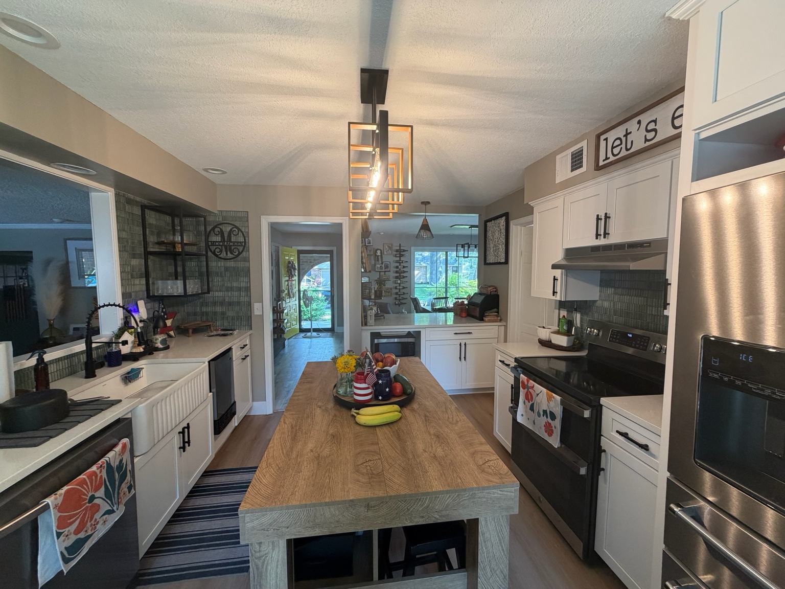 Completed kitchen viewed from the built-in coffee area toward the island and range