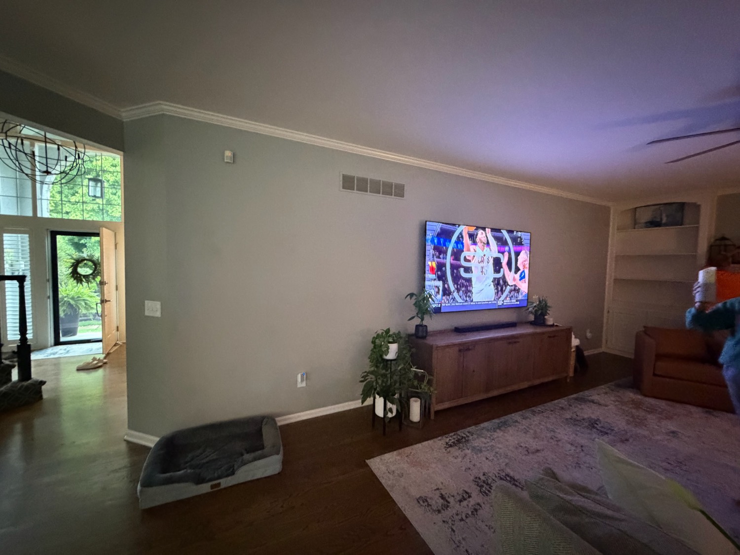 Living room before the work, showing a plain painted wall behind the television
